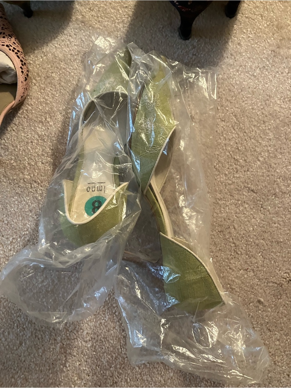 Green women's shoes in plastic